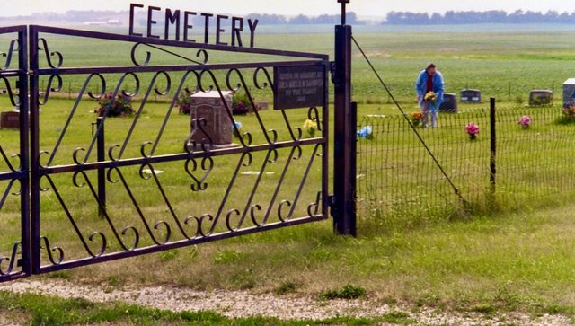 Saint Petri Cemetery side gate, with Peggy Stadum setting flowers
